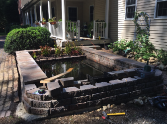 The waterfall box is hidden within the retaining wall. 